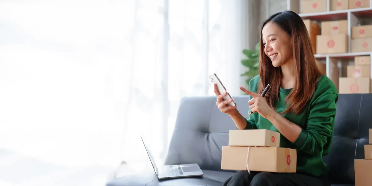 Happy businesswoman happily transacting thru mobile
