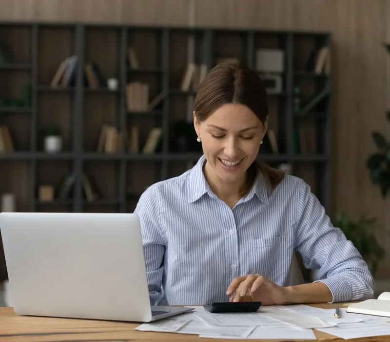 Happy woman looking at the calculator